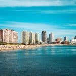 city skyline across body of water during daytime